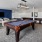 a room with a pool table and couches