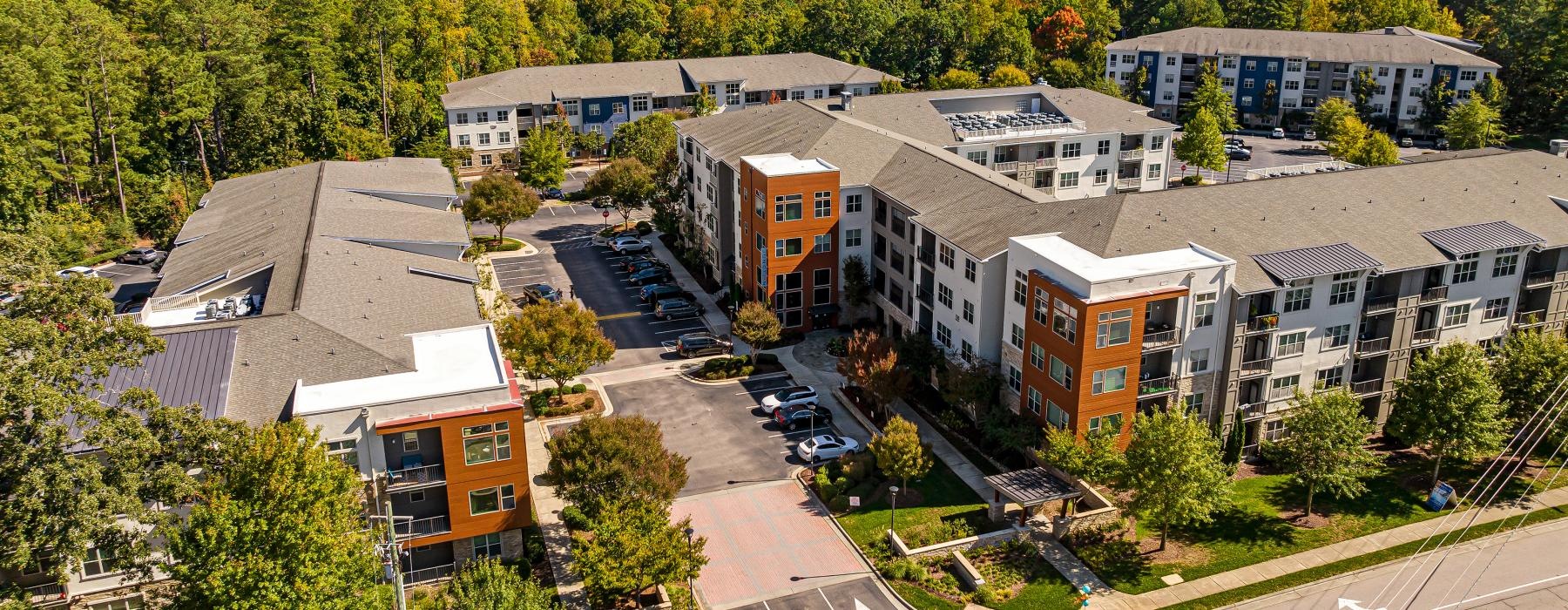 a group of buildings with trees in the front