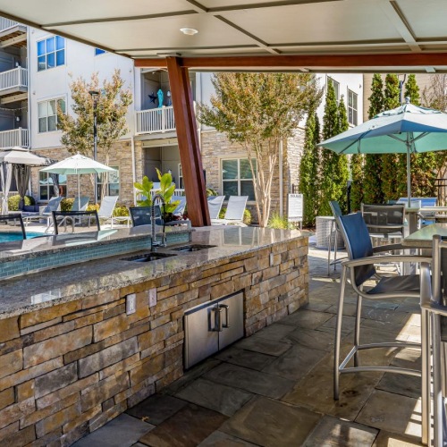 Access to resident-only features a patio with chairs and umbrellas