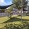 a playground with a fence and trees